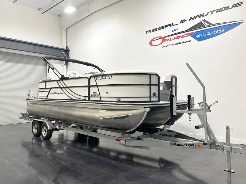 Slide: The Image of 2022 South Bay 222RS pontoon boat on trailer in showroom. - 1