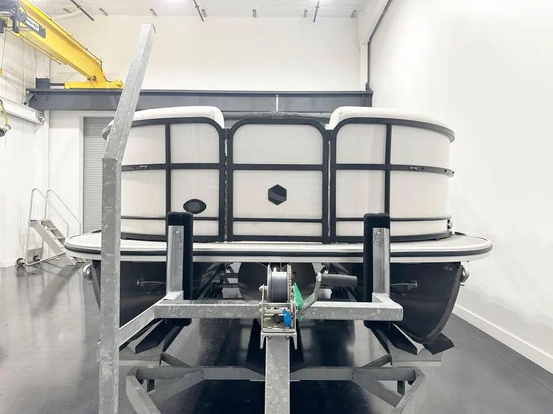Slide: The Image of 2022 South Bay 222RS pontoon boat on trailer in indoor storage. - 3