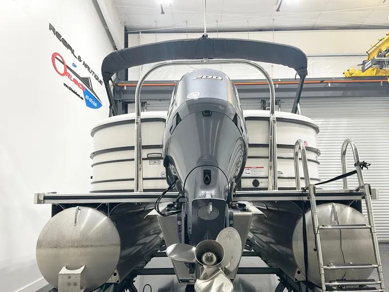 Slide: The Image of 2022 South Bay 222RS pontoon boat with outboard motor in a showroom. - 4
