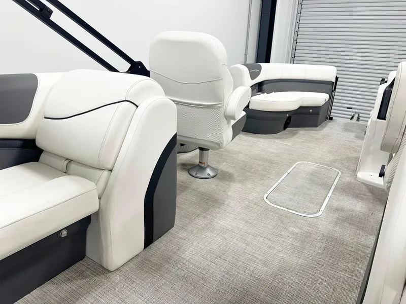 Slide: The Image of 2022 South Bay 222RS pontoon boat interior with plush white seating and modern design. - 5