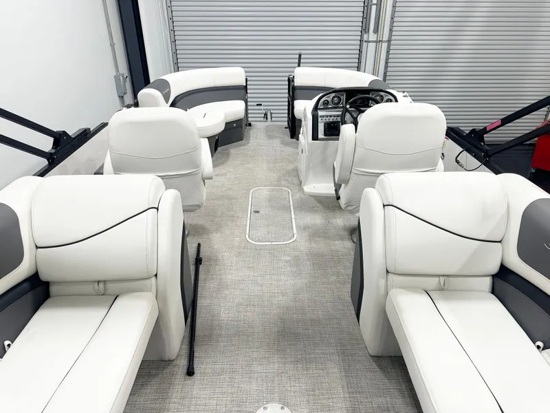 Slide: The Image of 2022 South Bay 222RS pontoon boat interior with white seating and modern dashboard. - 6