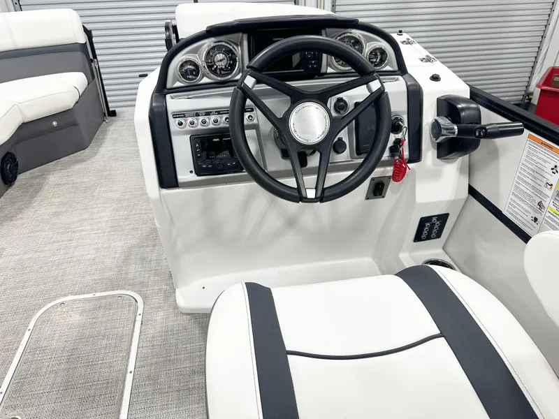 Slide: The Image of 2022 South Bay 222RS boat interior with steering wheel and control panel. - 7