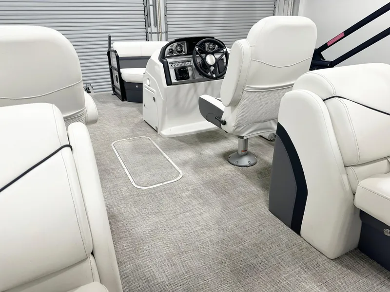 Slide: The Image of Interior of 2022 South Bay 222RS boat with plush white seating and modern dashboard. - 9