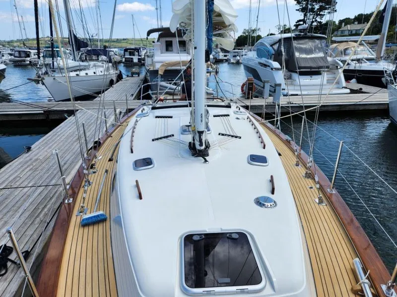 Slide: The Image of 2025 Rustler 37 yacht docked at marina, showcasing sleek deck design and modern features. - 11