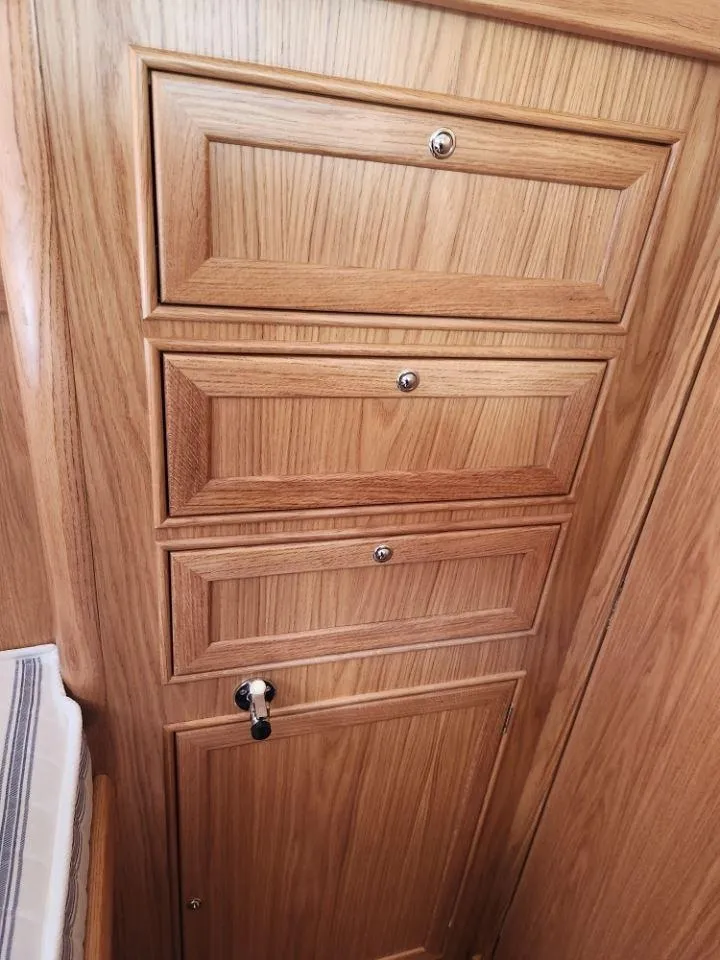 Slide: The Image of Wooden cabinetry inside a 2025 Rustler 37 yacht, featuring elegant panel design and secure locks. - 20