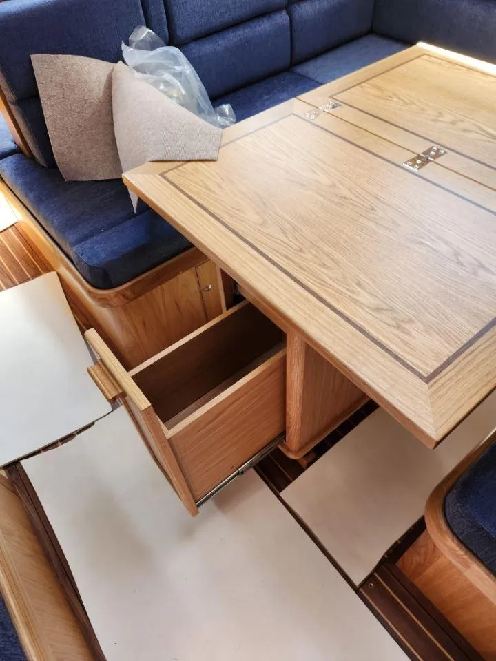 Slide: The Image of Interior of 2025 Rustler 37 yacht with wooden table and open drawer. - 24