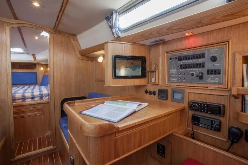 Slide: The Image of Interior of 2025 Rustler 37 yacht with navigation station and cozy cabin. - 27