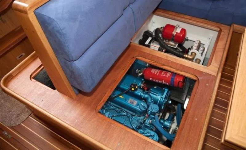 Slide: The Image of Engine compartment of 2025 Rustler 37 yacht, featuring blue engine and fire extinguisher. - 47