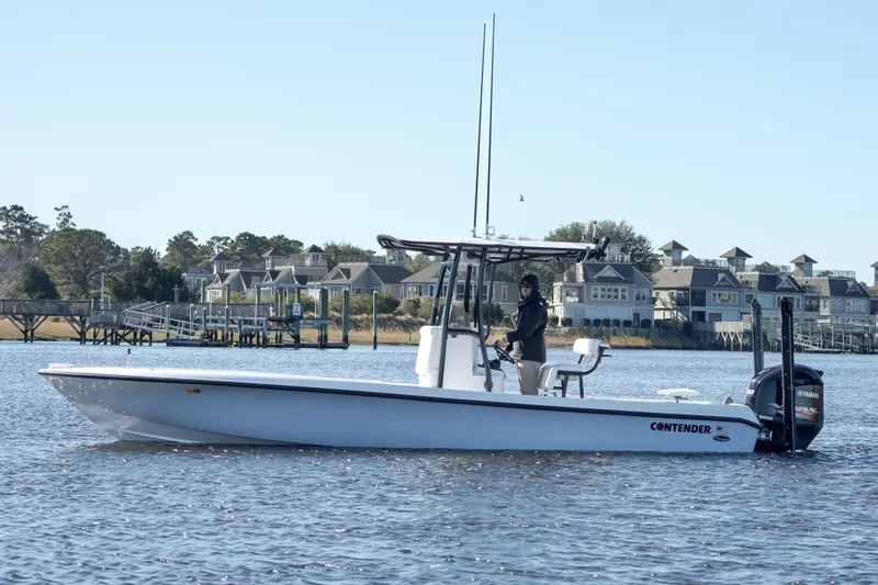 Slide: The Image of 2021 Contender 25 Bay boat on calm water near waterfront homes. - 3