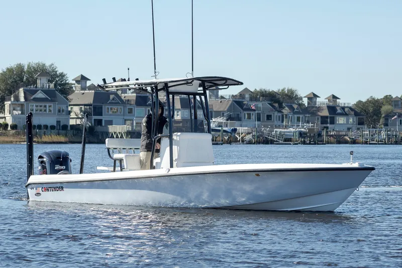 Slide: The Image of 2021 Contender 25 Bay boat on water near residential area. - 6