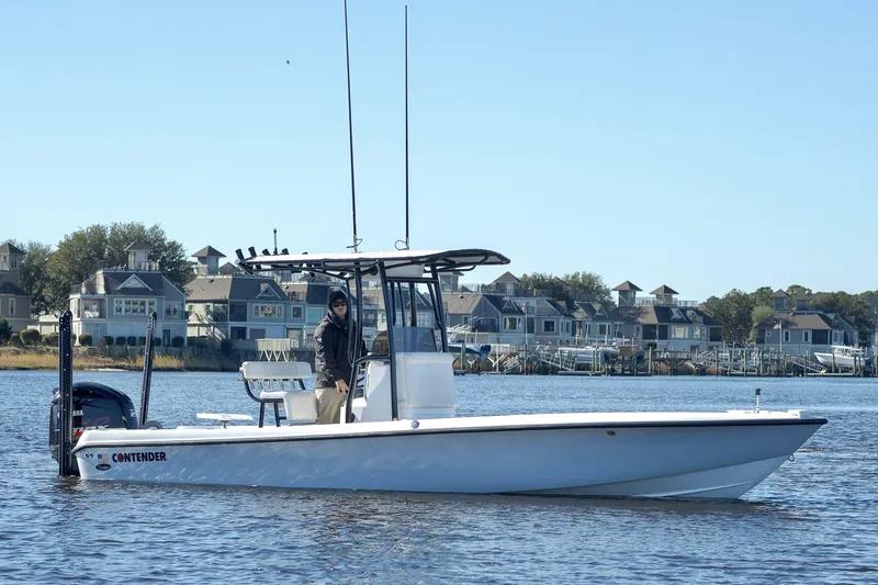 Slide: The Image of 2021 Contender 25 Bay boat on water near waterfront homes. - 7