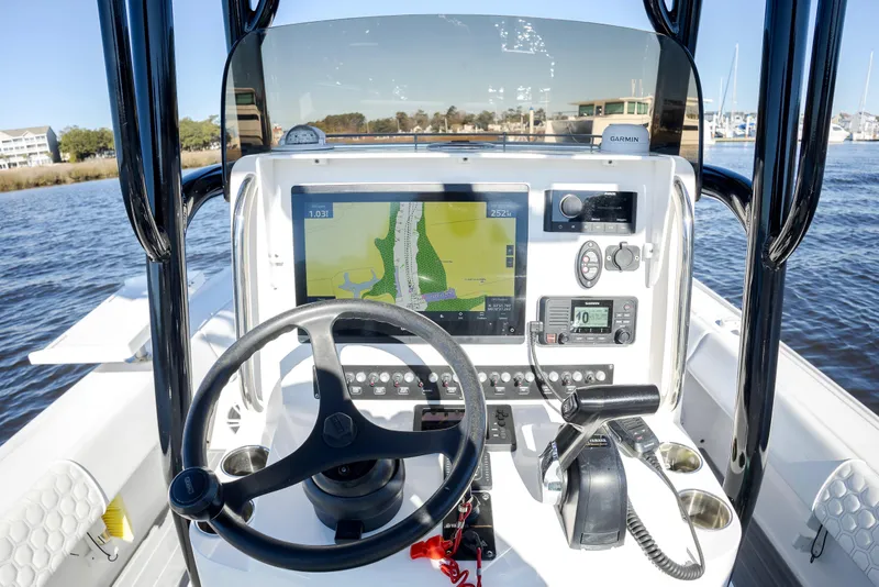 Slide: The Image of 2021 Contender 25 Bay boat dashboard with navigation system and controls. - 9