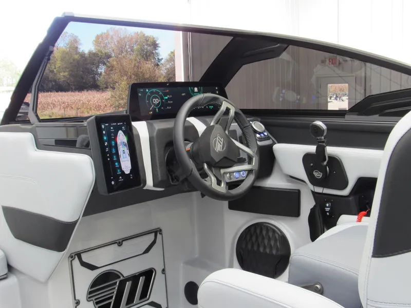 Slide: The Image of 2025 Malibu 23 LSV boat interior with modern dashboard and steering wheel. - 10