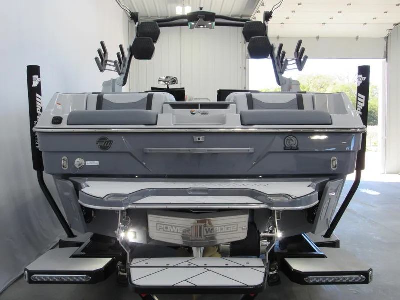 Slide: The Image of 2025 Malibu 23 LSV boat, rear view in a garage, showcasing sleek design and modern features. - 3