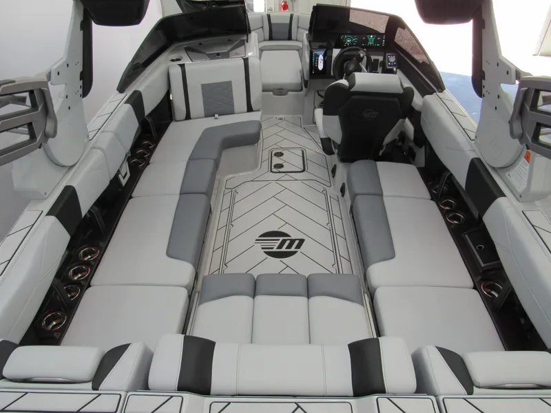 Slide: The Image of 2025 Malibu 23 LSV boat interior with sleek seating and modern dashboard design. - 4