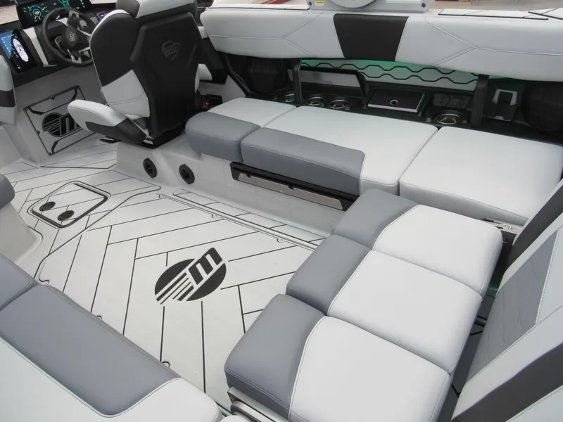 Slide: The Image of 2025 Malibu 23 LSV boat interior with sleek gray and white seating and modern design. - 5