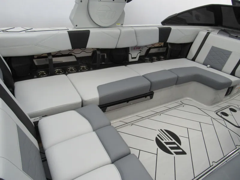 Slide: The Image of 2025 Malibu 23 LSV boat interior with gray and white seating. - 7