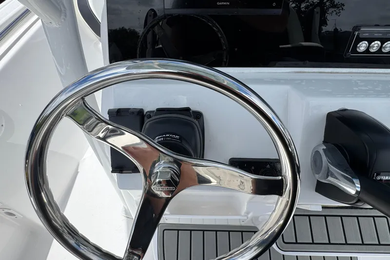 Slide: The Image of Steering wheel and controls of 2025 Tidewater 210 LXF boat cockpit. - 10