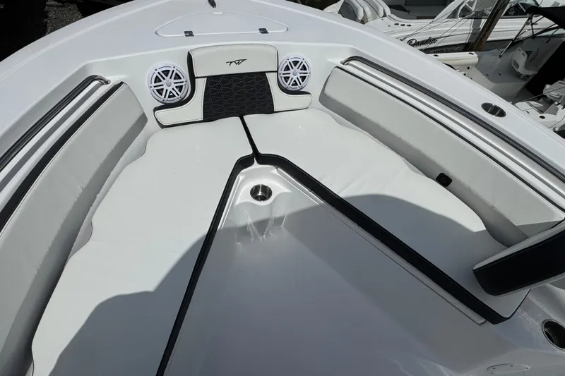 Slide: The Image of 2025 Tidewater 210 LXF boat interior with cushioned seating and speakers. - 16