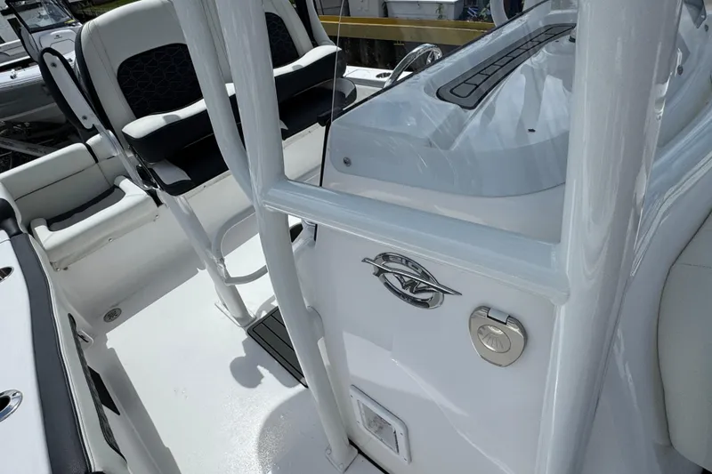 Slide: The Image of 2025 Tidewater 210 LXF boat interior with seating and console details. - 19