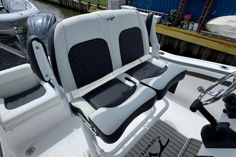 Slide: The Image of 2025 Tidewater 210 LXF boat interior with dual seats and steering wheel. - 4