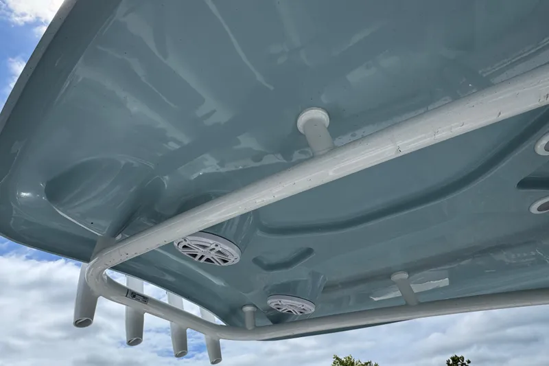 Slide: The Image of 2025 Tidewater 210 LXF boat roof with speakers and rod holders against blue sky. - 5