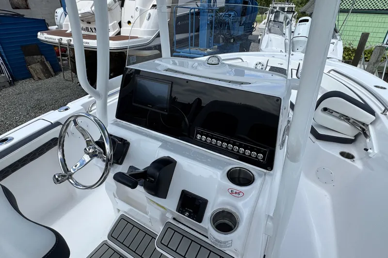 Slide: The Image of 2025 Tidewater 210 LXF boat dashboard with steering wheel and control panel. - 6
