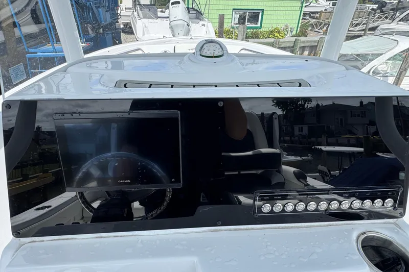 Slide: The Image of 2025 Tidewater 210 LXF boat dashboard with Garmin display and control panel. - 7