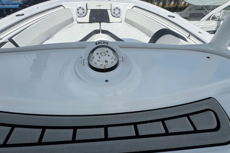 Slide: The Image of 2025 Tidewater 210 LXF boat interior with Ritchie compass and seating area. - 8