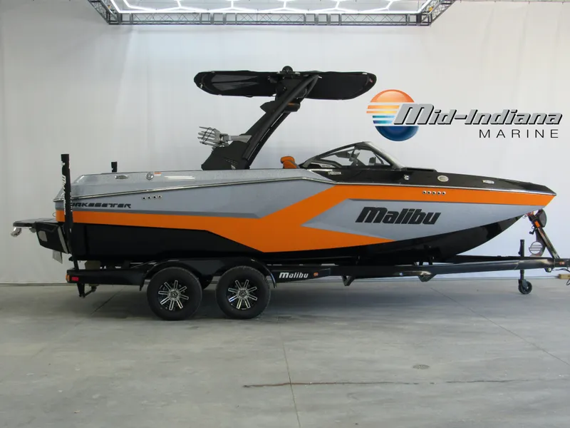 Slide: The Image of 2025 Malibu Wakesetter 22 MXZ boat on trailer at Mid-Indiana Marine showroom. - 0