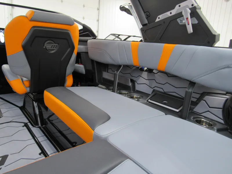 Slide: The Image of 2025 Malibu Wakesetter 22 MXZ interior with gray and orange seating. - 11