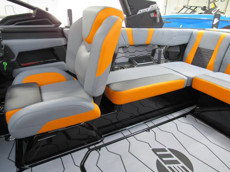 Slide: The Image of 2025 Malibu Wakesetter 22 MXZ interior with orange and gray seating. - 12