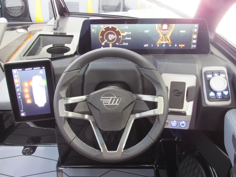 Slide: The Image of 2025 Malibu Wakesetter 22 MXZ dashboard with modern steering wheel and digital displays. - 14