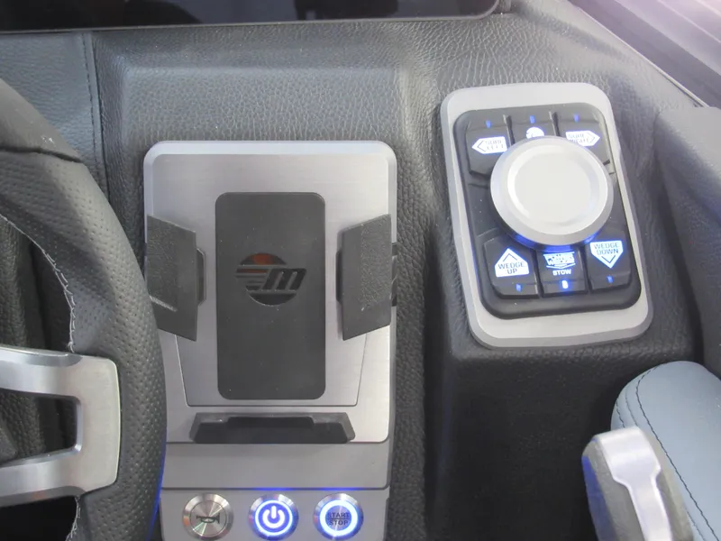 Slide: The Image of 2025 Malibu Wakesetter 22 MXZ dashboard with control panel and steering wheel. - 16