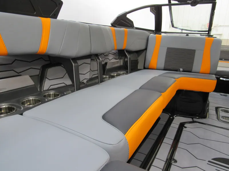 Slide: The Image of 2025 Malibu Wakesetter 22 MXZ interior with gray and orange seating. - 9