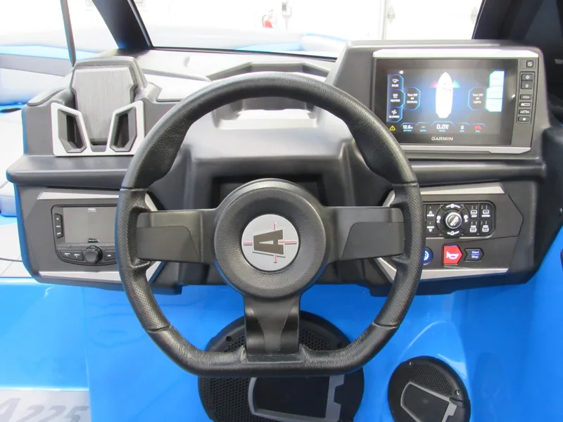 Slide: The Image of 2025 Axis A225 boat dashboard with steering wheel and digital display. - 12
