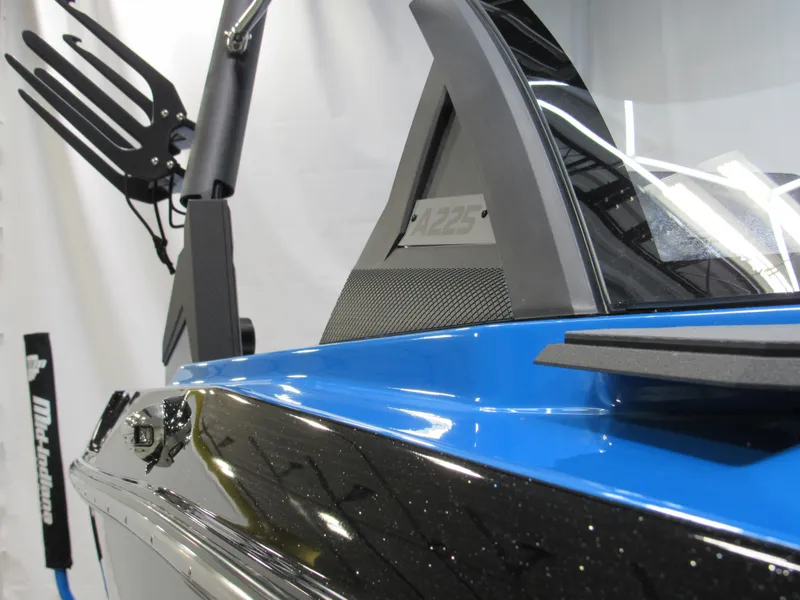 Slide: The Image of 2025 Axis A225 boat, sleek blue and black design, close-up view. - 3