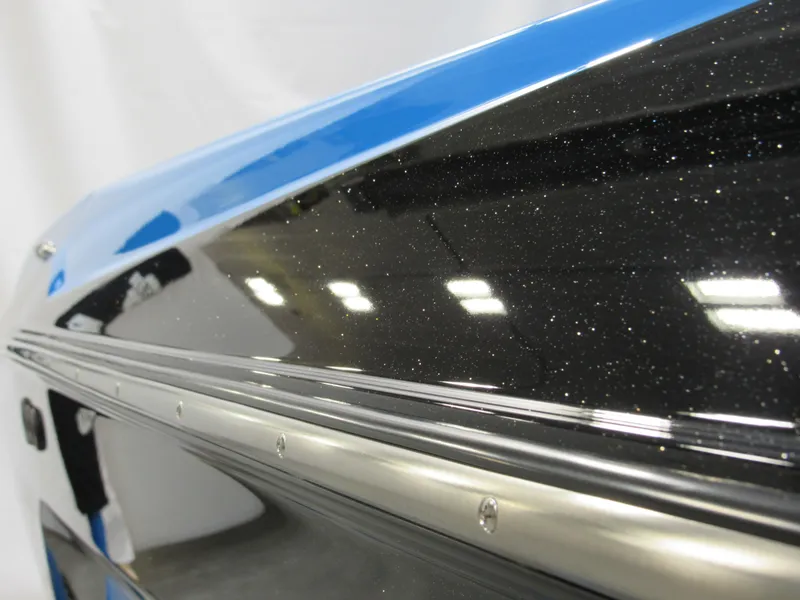 Slide: The Image of Close-up of 2025 Axis A225 boat hull with sleek black and blue finish. - 4