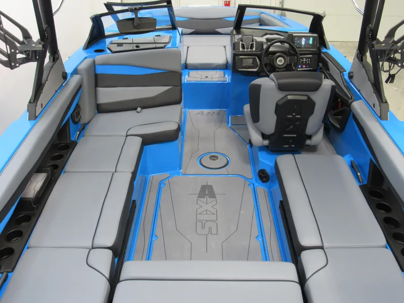 Slide: The Image of 2025 Axis A225 boat interior with gray seating and blue accents. - 5