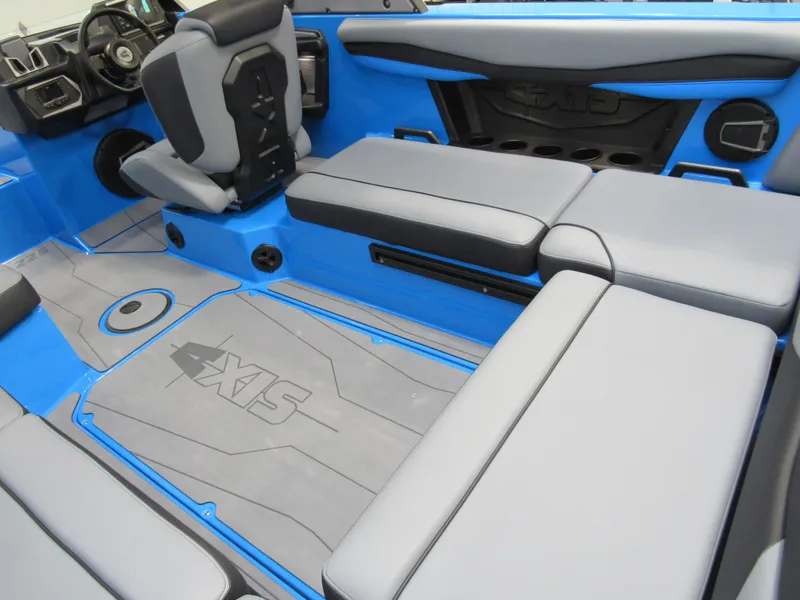 Slide: The Image of 2025 Axis A225 boat interior with blue and gray seating and flooring. - 6
