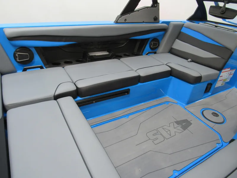 Slide: The Image of 2025 Axis A225 boat interior with gray and blue seating and flooring. - 8