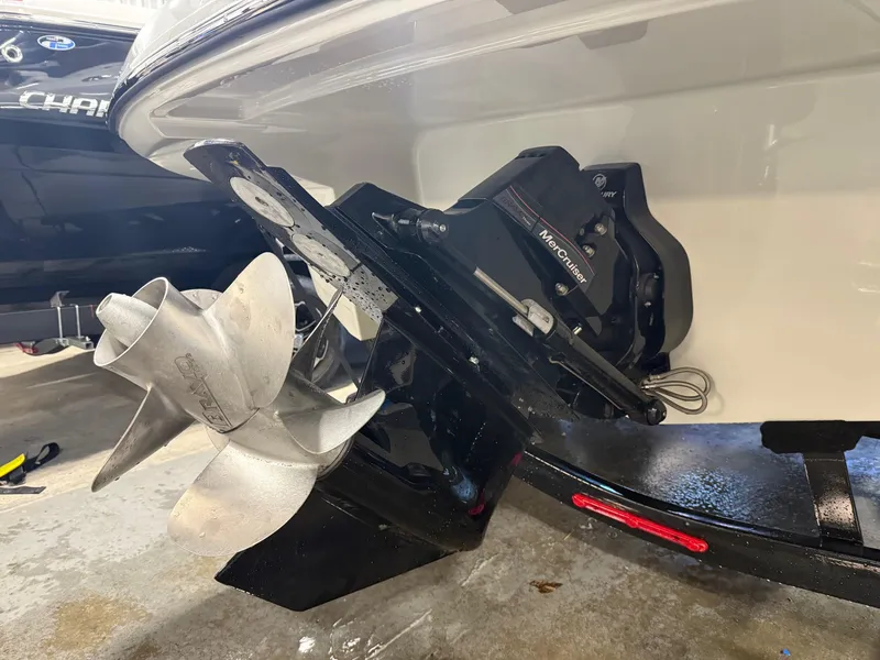 Slide: The Image of 2024 Crownline Eclipse E235 boat with Mercury outboard motor and propeller. - 11