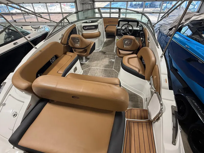 Slide: The Image of 2024 Crownline Eclipse E235 boat interior with tan leather seating and modern dashboard. - 3