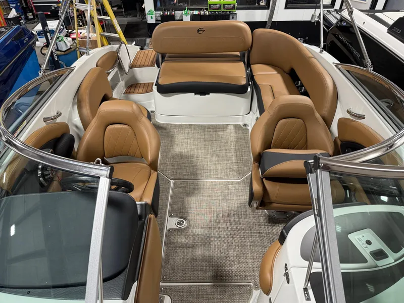 Slide: The Image of 2024 Crownline Eclipse E235 boat interior with tan seating and modern design. - 4