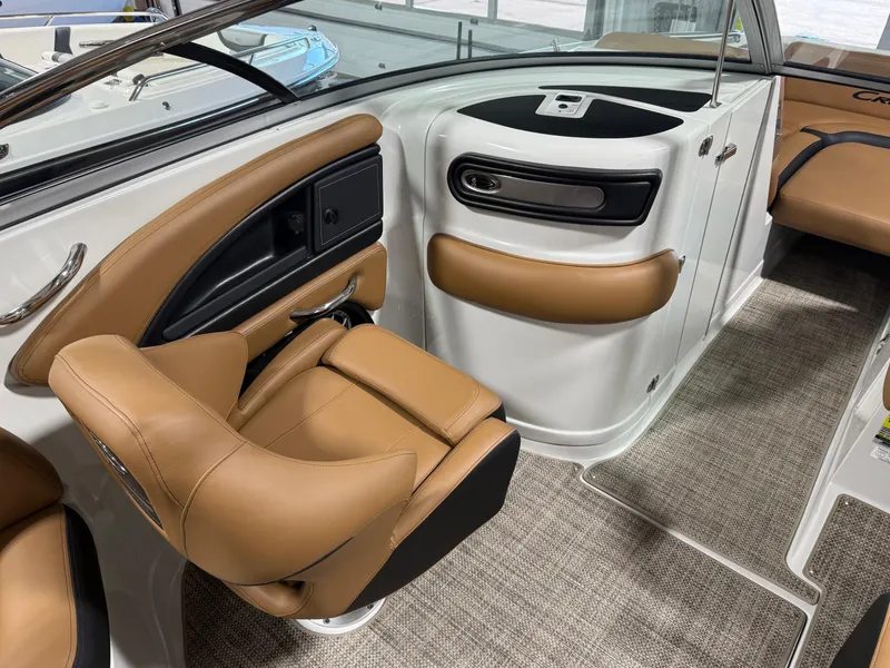 Slide: The Image of 2024 Crownline Eclipse E235 boat interior with tan leather seating and modern design. - 8