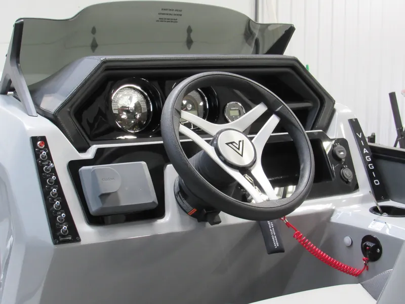 Slide: The Image of Viaggio Lago X22U 2025 boat dashboard with steering wheel and control panel. - 4