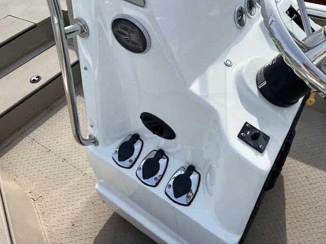 Slide: The Image of 2023 SeaArk Bayrunner 210 boat console with controls and steering wheel. - 11