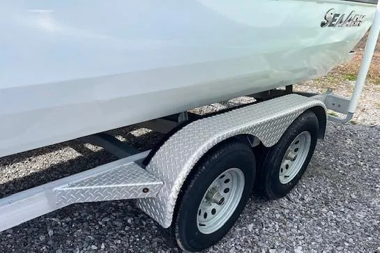 Slide: The Image of 2023 SeaArk Bayrunner 210 boat on a dual-axle trailer, side view. - 12