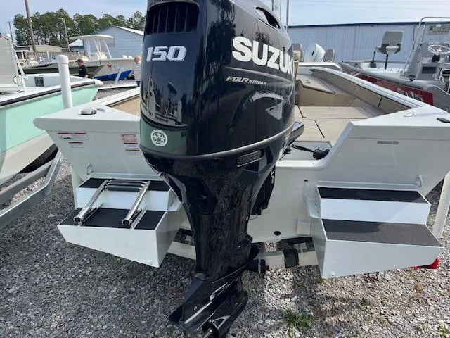 Slide: The Image of 2023 SeaArk Bayrunner 210 with Suzuki 150 outboard motor, parked on gravel. - 4