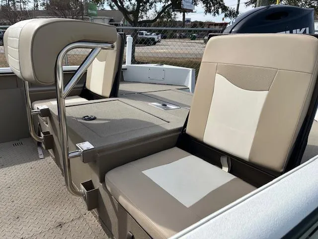 Slide: The Image of 2023 SeaArk Bayrunner 210 boat interior with beige seating and metal frame. - 5